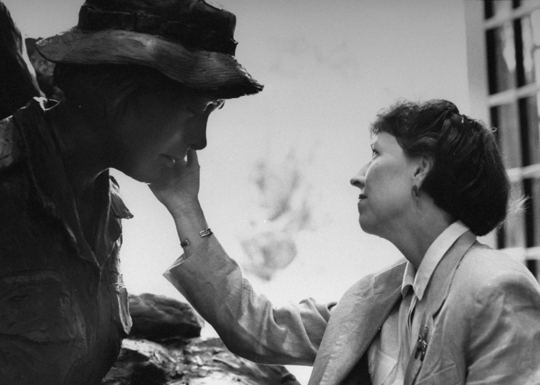 Diane Carlson Evans touches a monument by artist Glenna Goodacre.