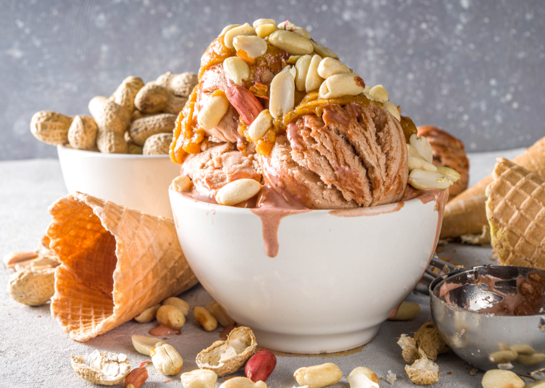Bowl of peanut butter ice cream with peanut toppings.