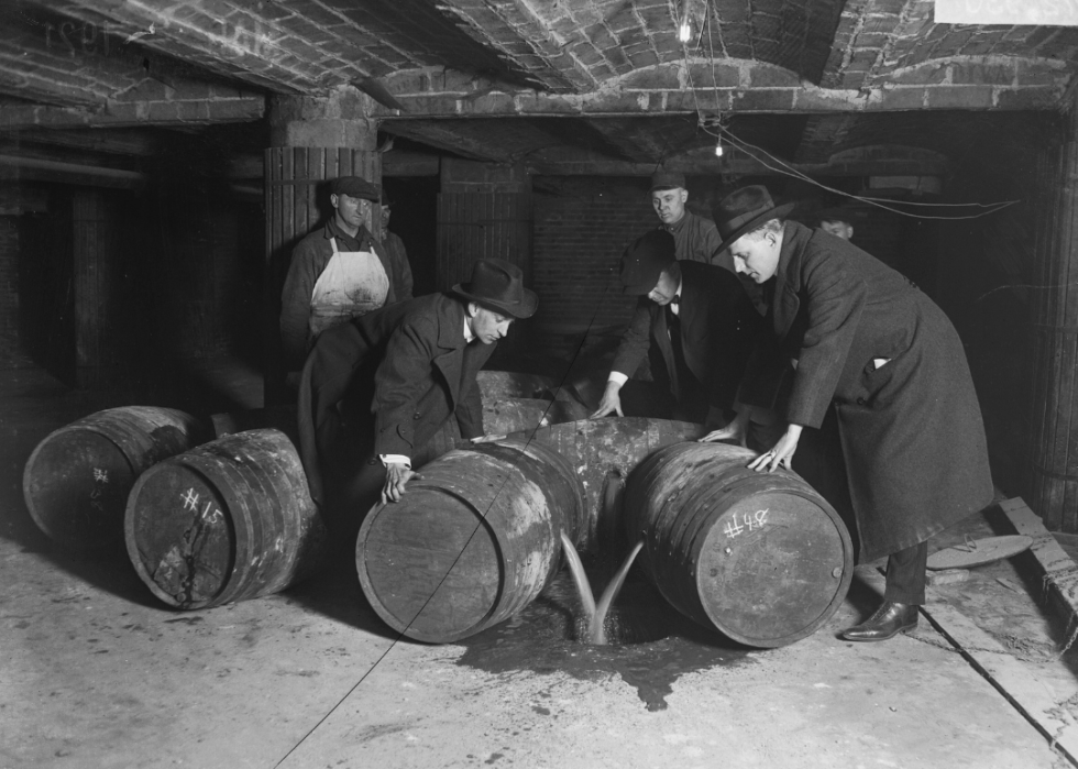 Men dumping wine during prohibition