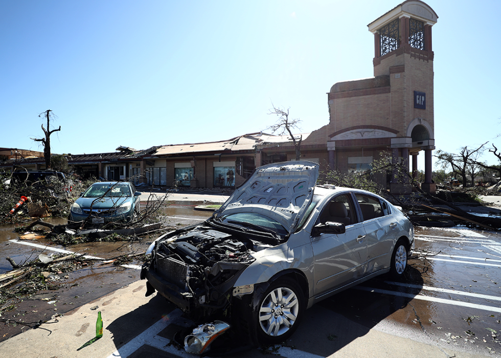 Tornado damage to vehicles and building in the Preston Royal shopping area.