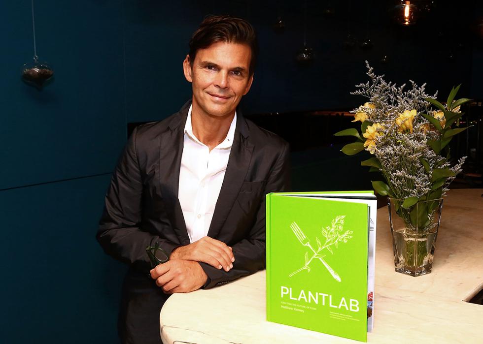 Matthew Kenney poses with his book Plant Lab: Crafting The Future Of Food.