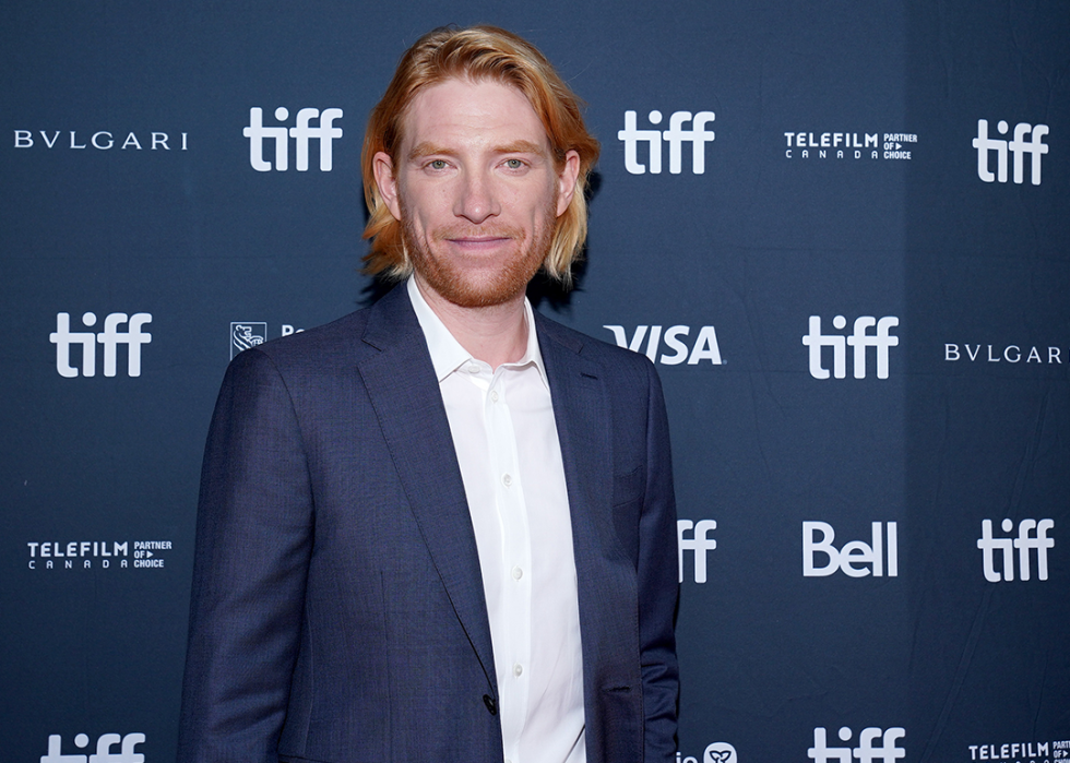 Domhnall Gleeson poses at a premiere.