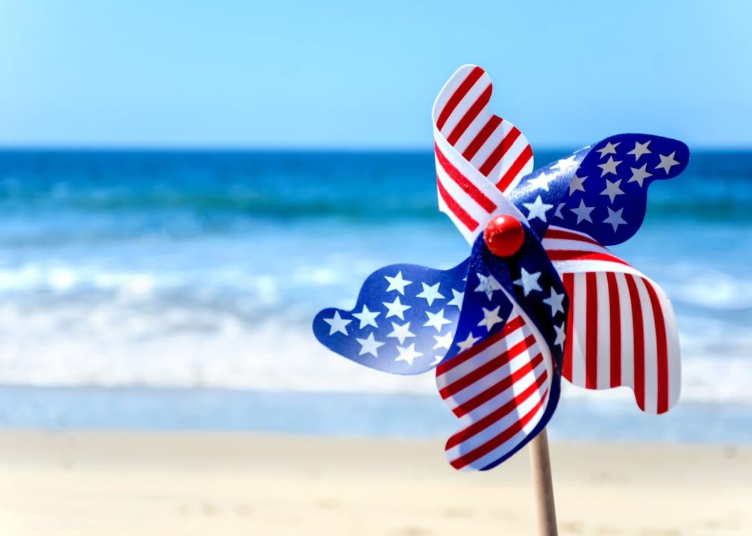 American flag pinwheel on beach.