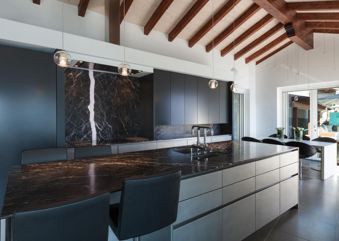 Modern kitchen with dramatic marble countertop and backsplash.