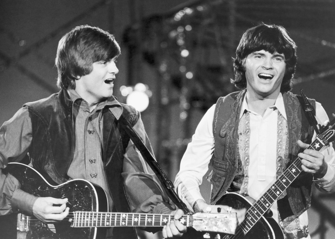 Phil Everly and Don Everly perform onstage.