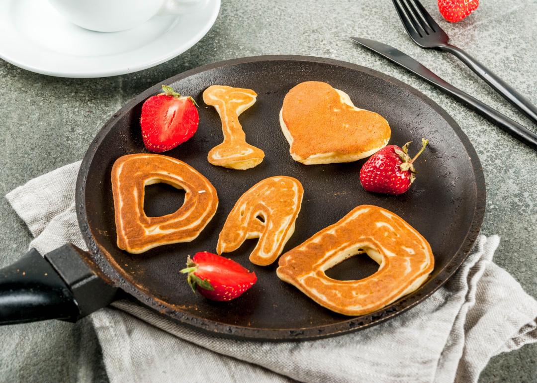 'I love Dad’-shaped pancakes in a frying pan.