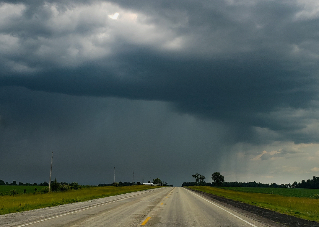 Storm cloud over rural landscape.