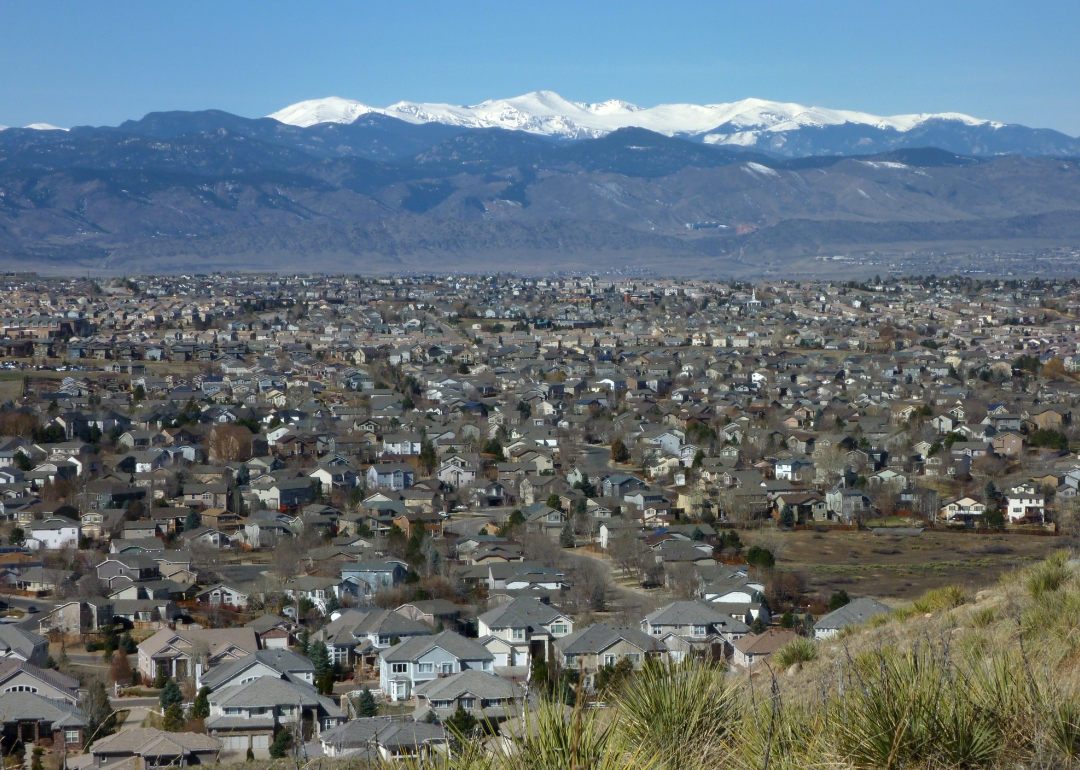Aerial view of Highlands Ranch homes and Rocky Mountains.
