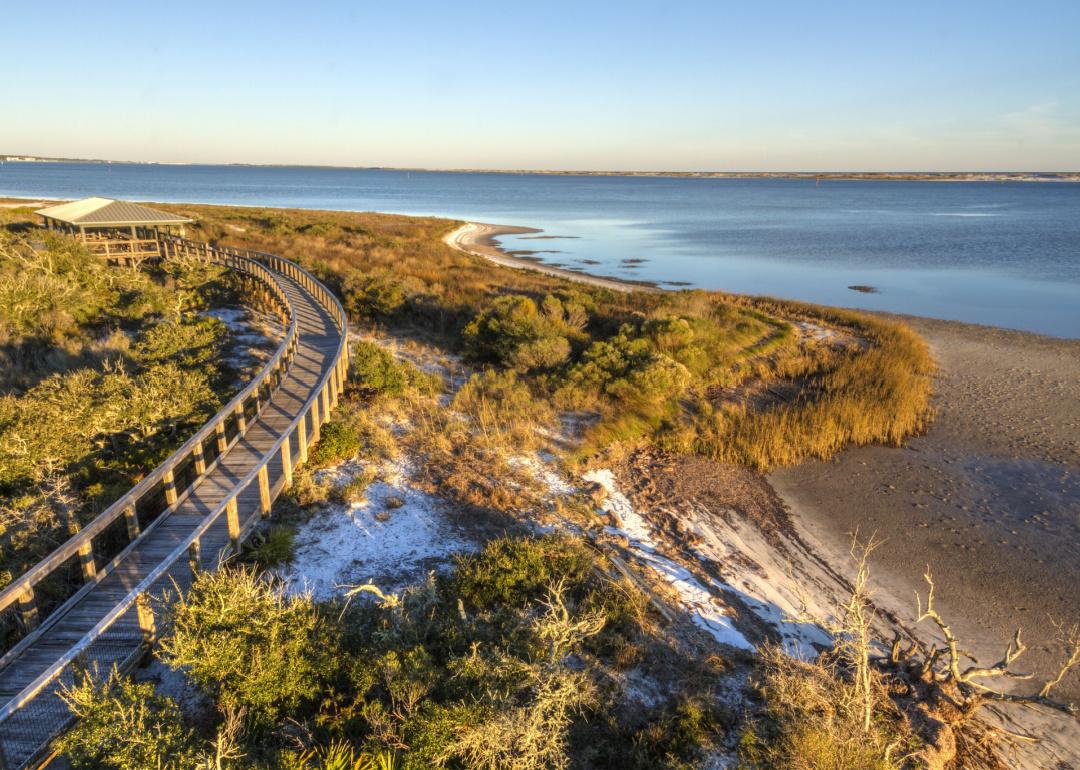 A boardwalk curves over the vegetation on the dunes in Big Lagoon State Park.