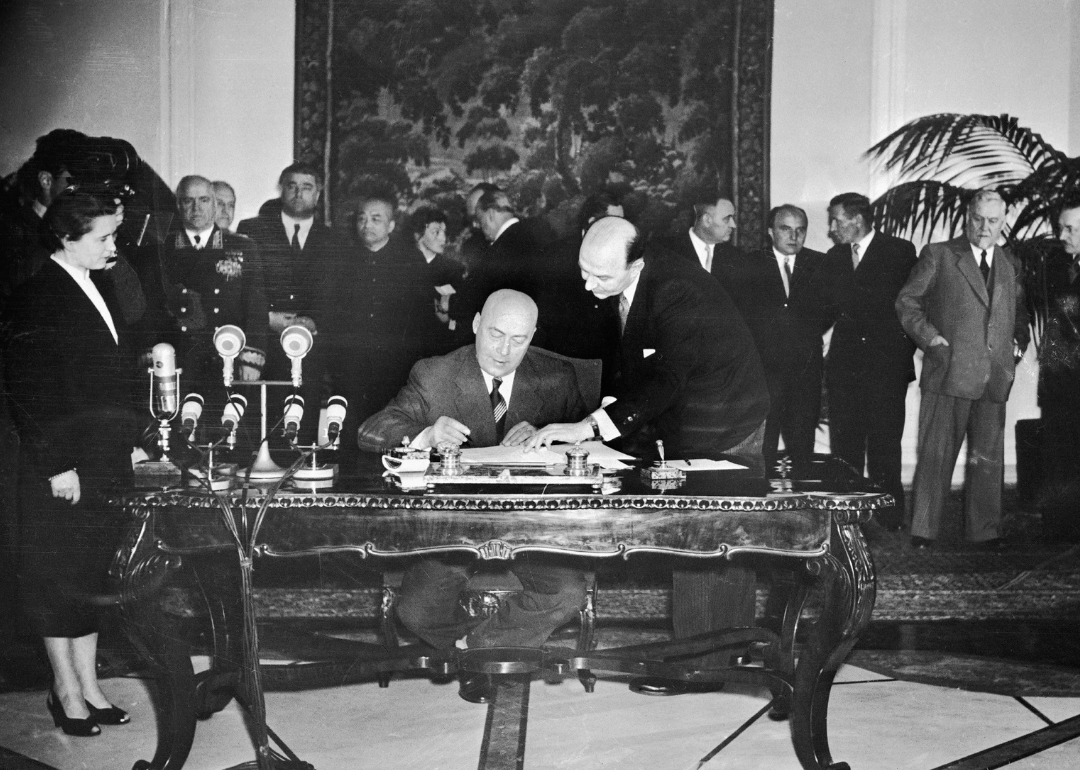 Poland's Prime Minister Jozef Cyrankiewicz signing The Warsaw Pact.