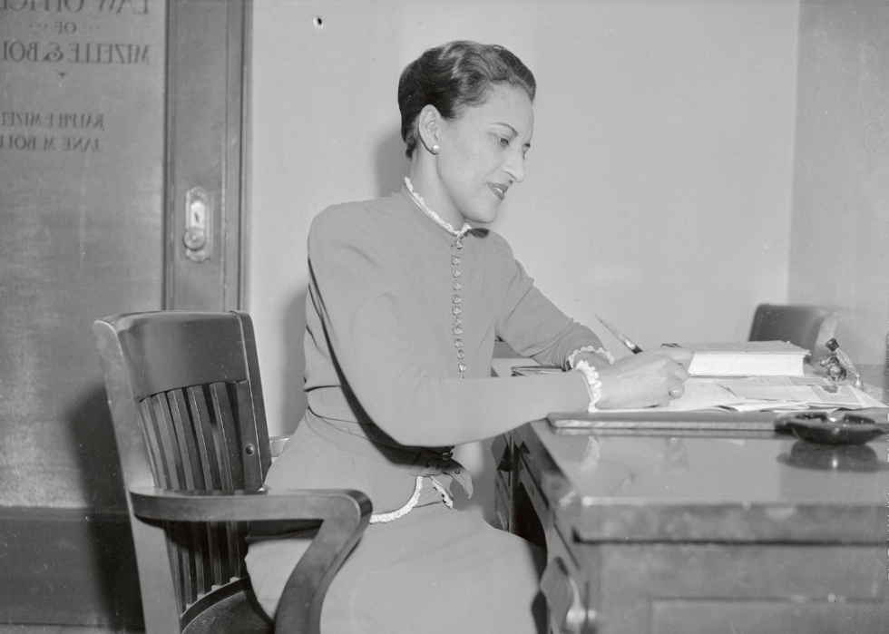 Jane Bolin seated at desk.