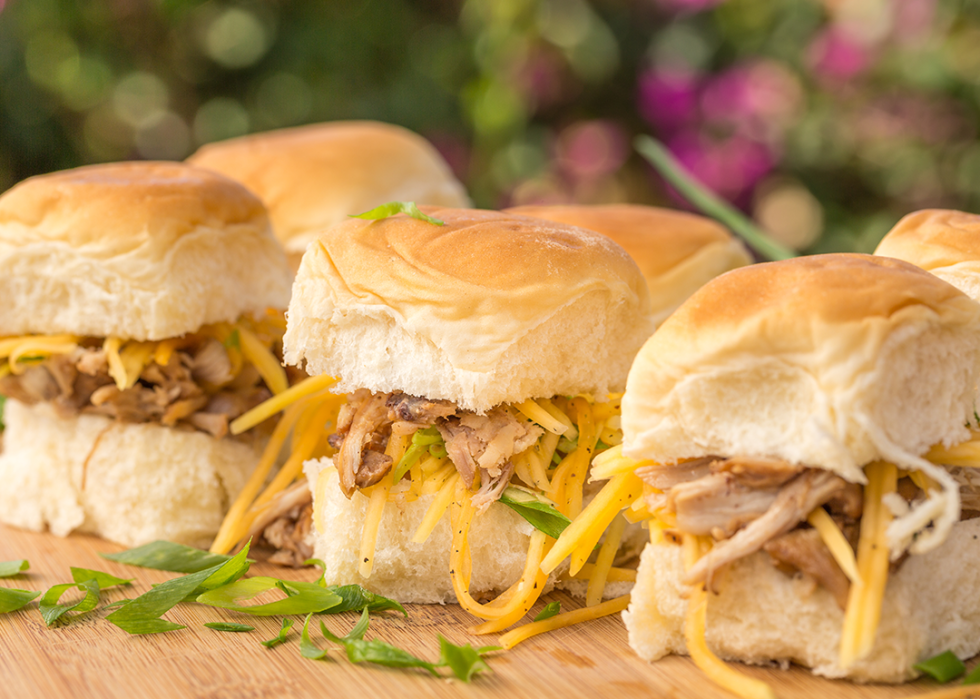 Kalua pork sliders on sweet Hawaiian bread with green onions and carrots.