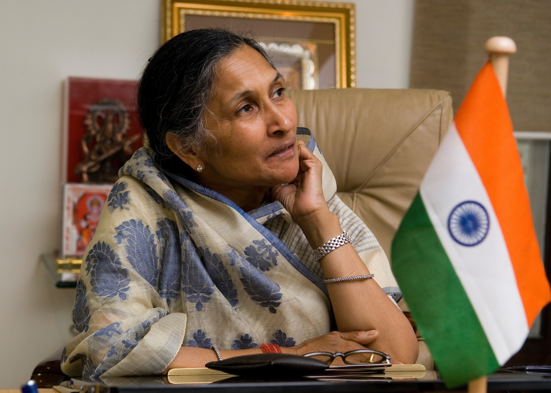 Savitri Jindal seated at desk.