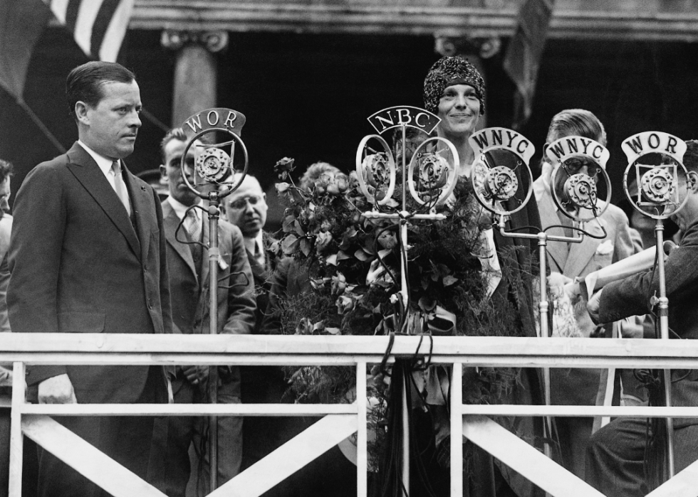 Amelia Earhart addressing the crowd and radio audience