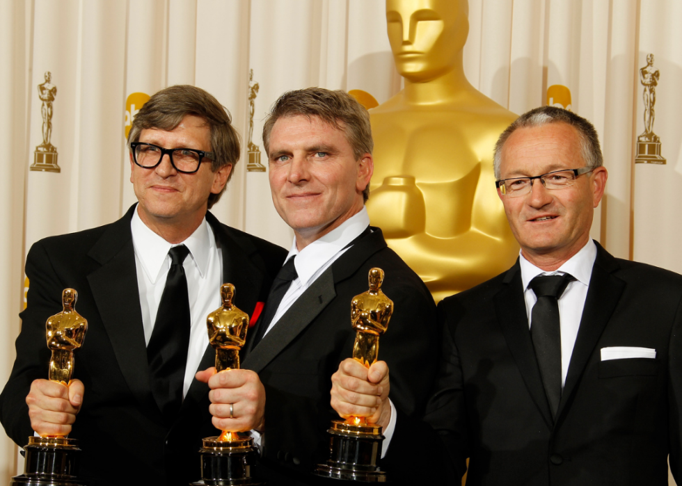 Rick Carter, Robert Stromberg and Kim Sinclair pose with their Oscars