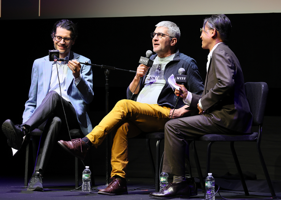 Nicholas Elliott, Alain Guiraudie, and Dennis Lim speak on stage at the "Misericordia" premiere during the 62nd New York Film Festival.