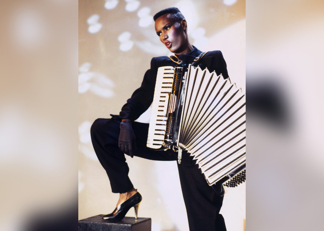 Grace Jones poses with accordion.