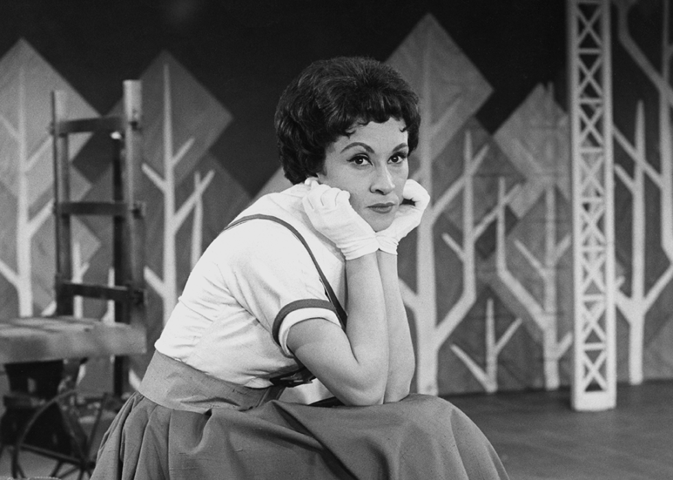 Chita Rivera posing for portrait on a stage.