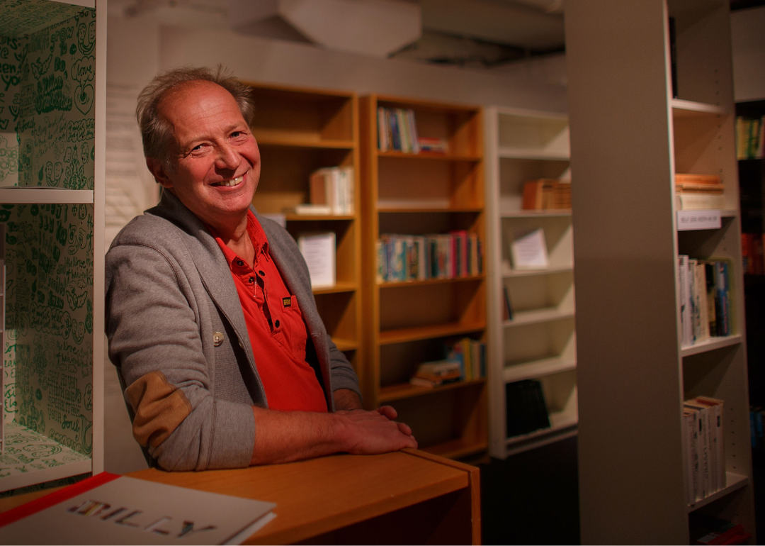 Boerje Lindgre sitting between bookshelves in the Ikea museum.