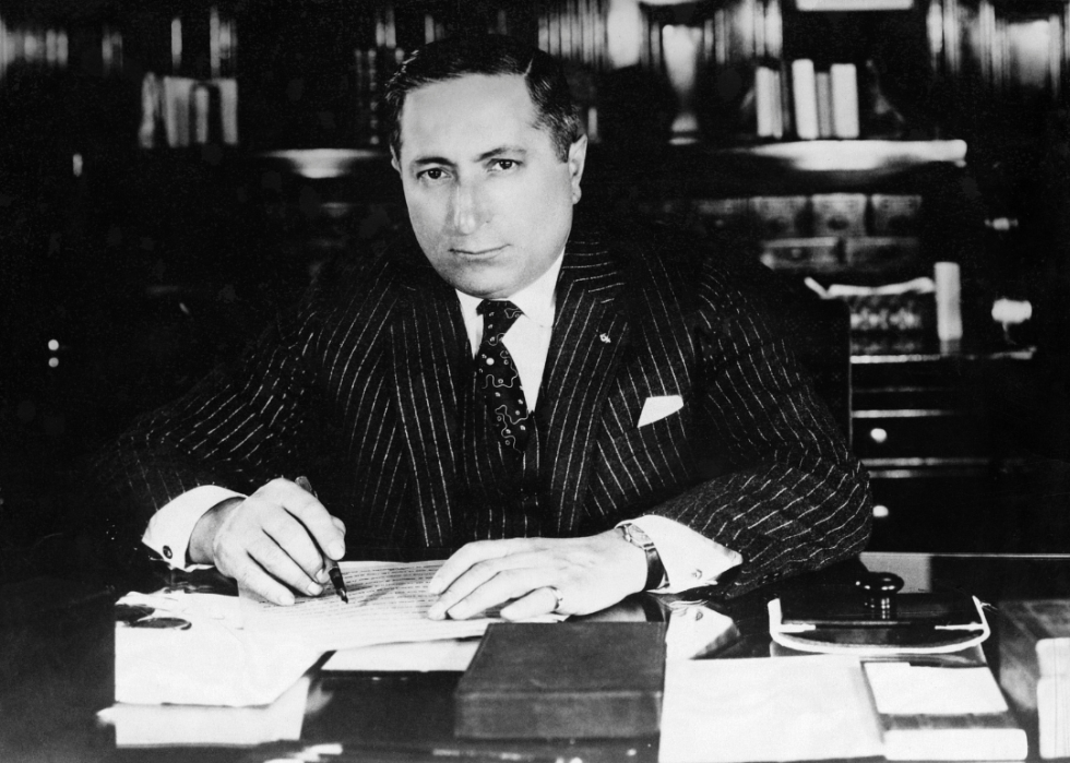 Louis Burt Mayer poses behind desk.