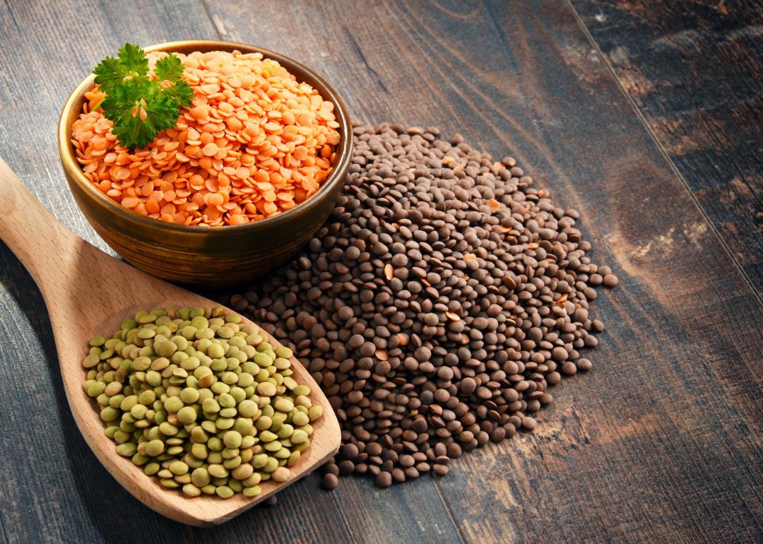 Three types of lentils on wood.