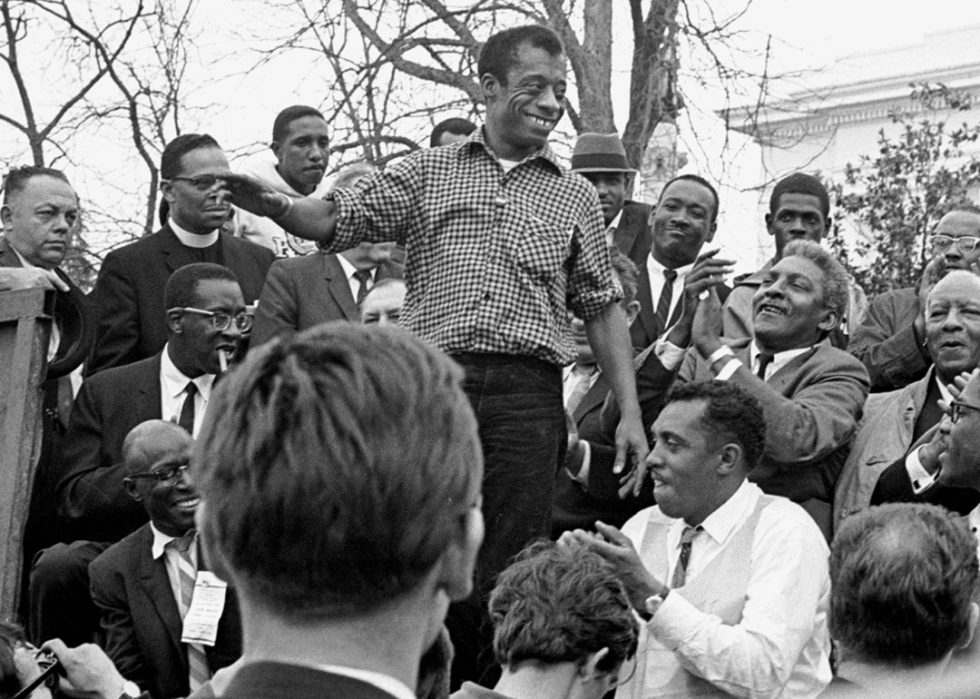 James Baldwin smiles from the speaker's platform after the Selma to Montgomery march.
