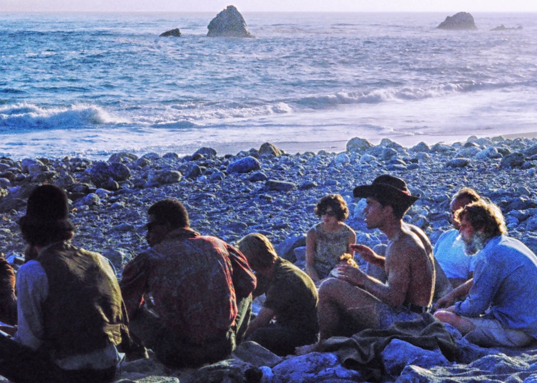 Hippies gathering at sunset on the beach.