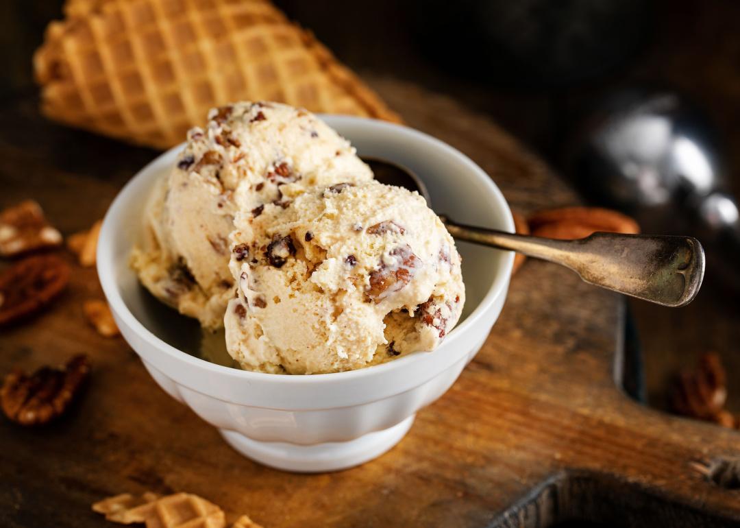 Bowl of butter pecan ice cream with spoon.