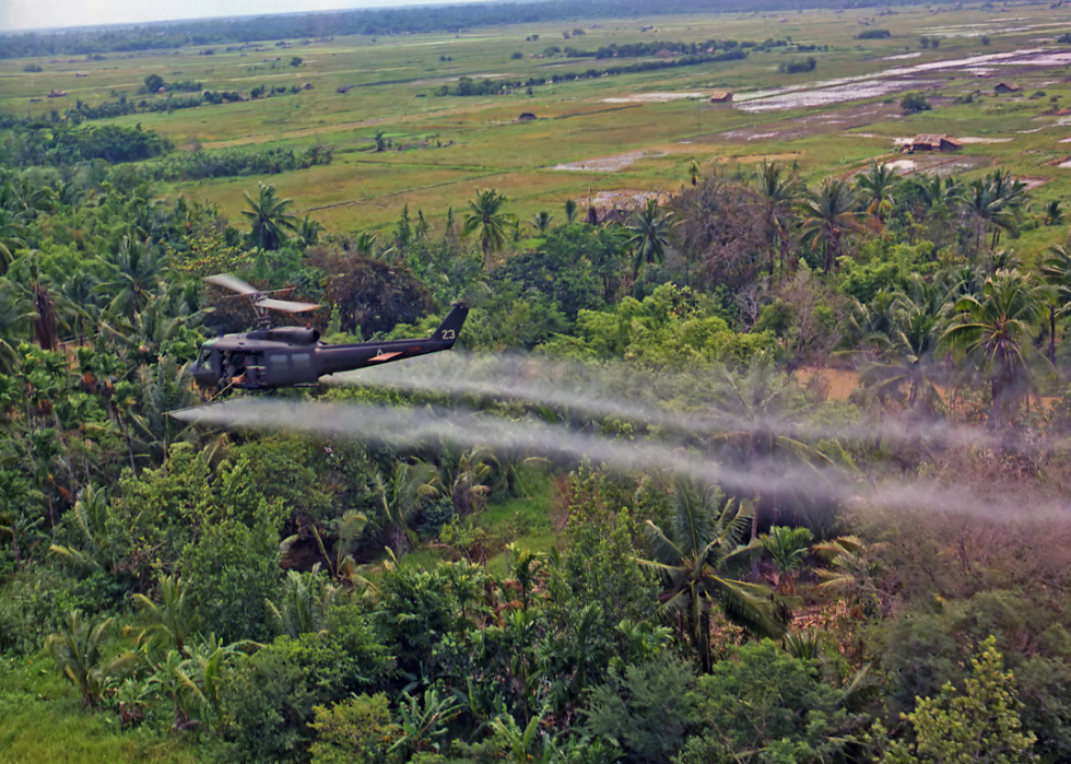 A helicopter sprays defoliation agent in Vietnam