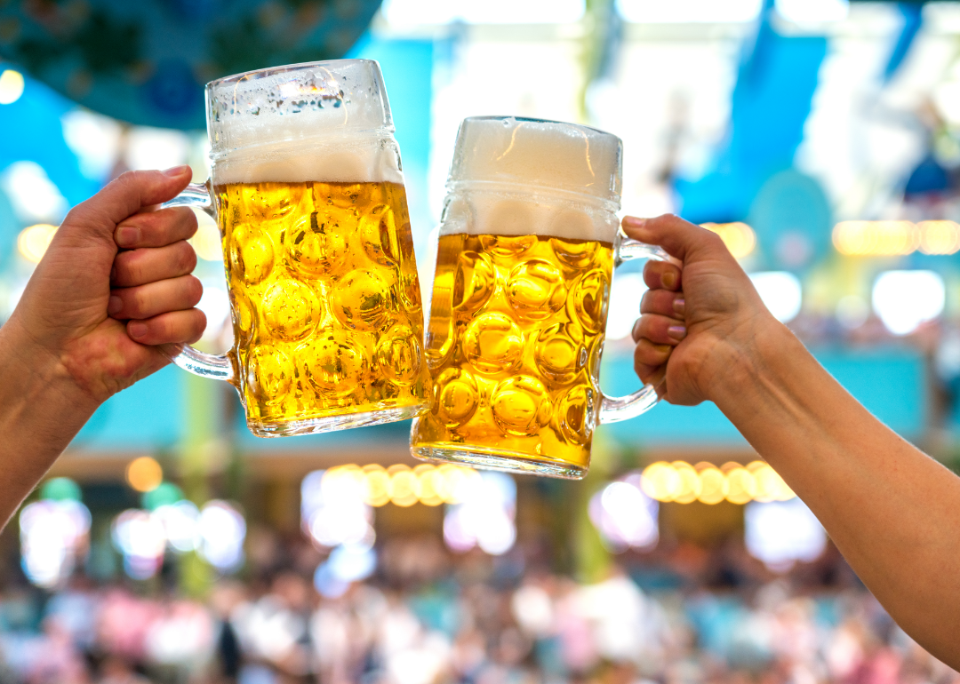 Two people raise mugs of German beer at Munich Beer Fest.