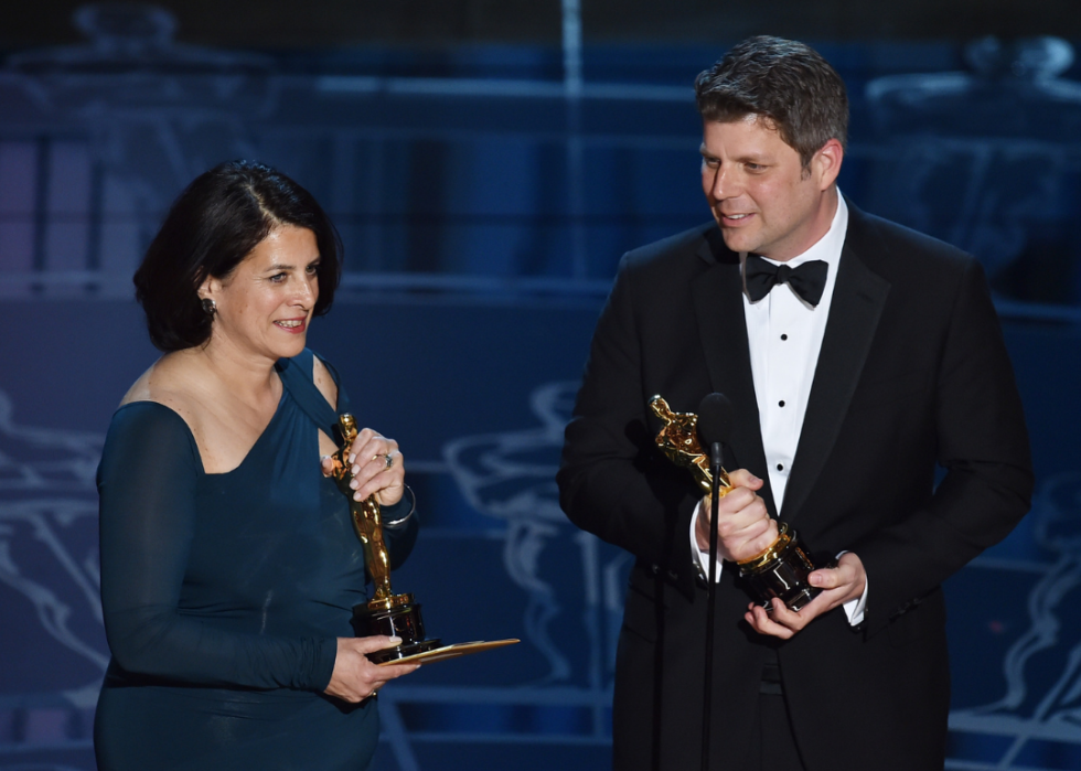 Adam Stockhausen and Anna Pinnock accept their Oscar
