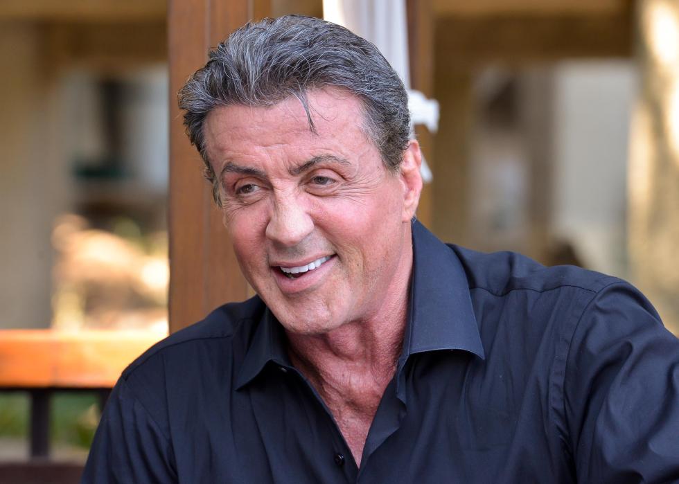 Sylvester Stallone smiles in an interview.