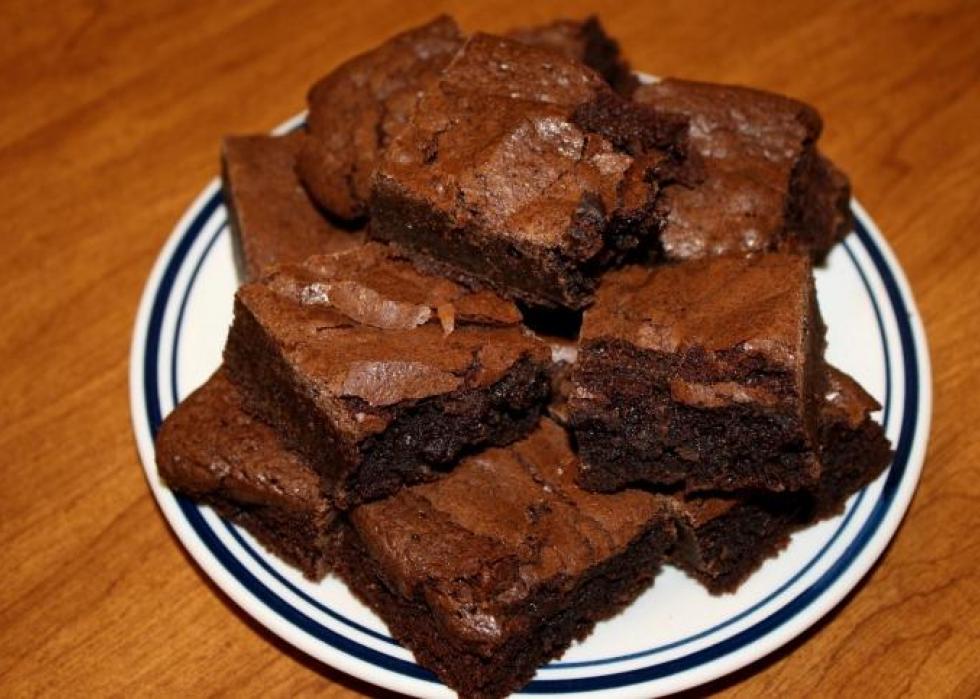 Chocolate brownies piled on a plate.
