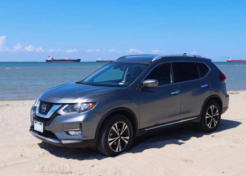 A 2018 Nissan Rogue car is parked on the beach.