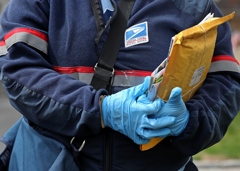 U.S. mail carrier with packages