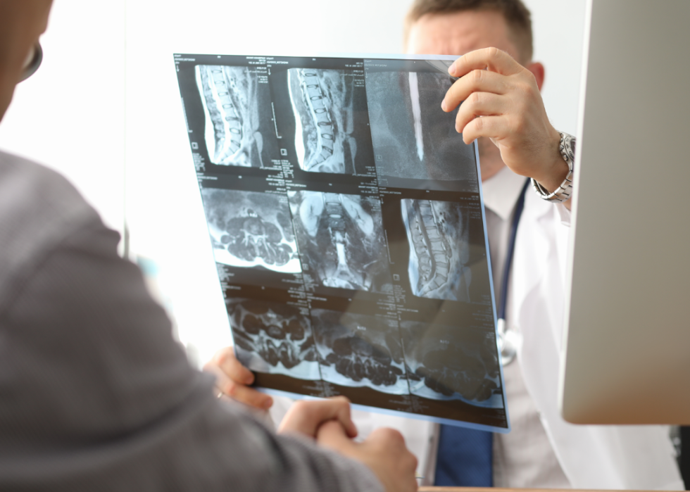Two doctors examine a series of xrays