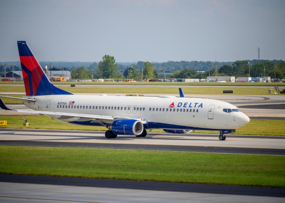 A Delta airways jet taxis along a runway