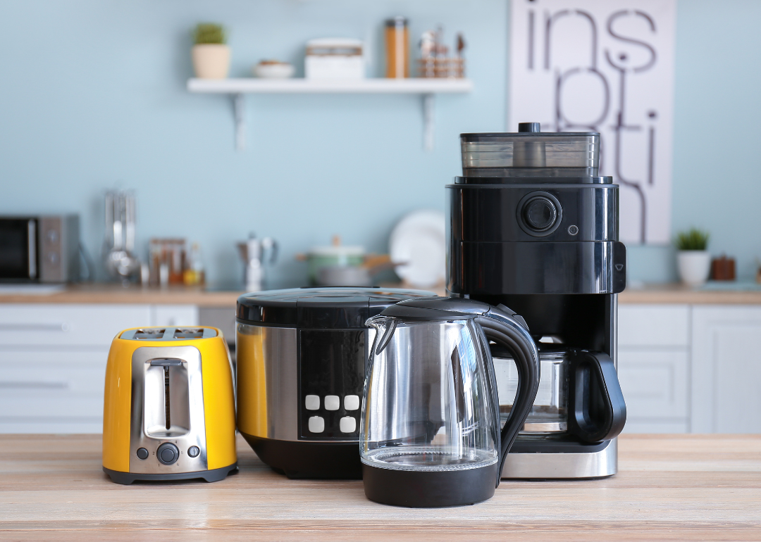 Kitchen counter with different kitchen appliances grouped together including blender and toaster