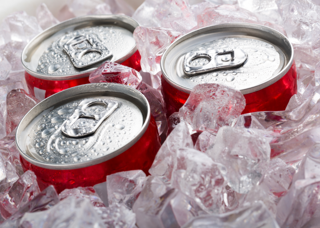 Three cans of diet cola submerged in ice.