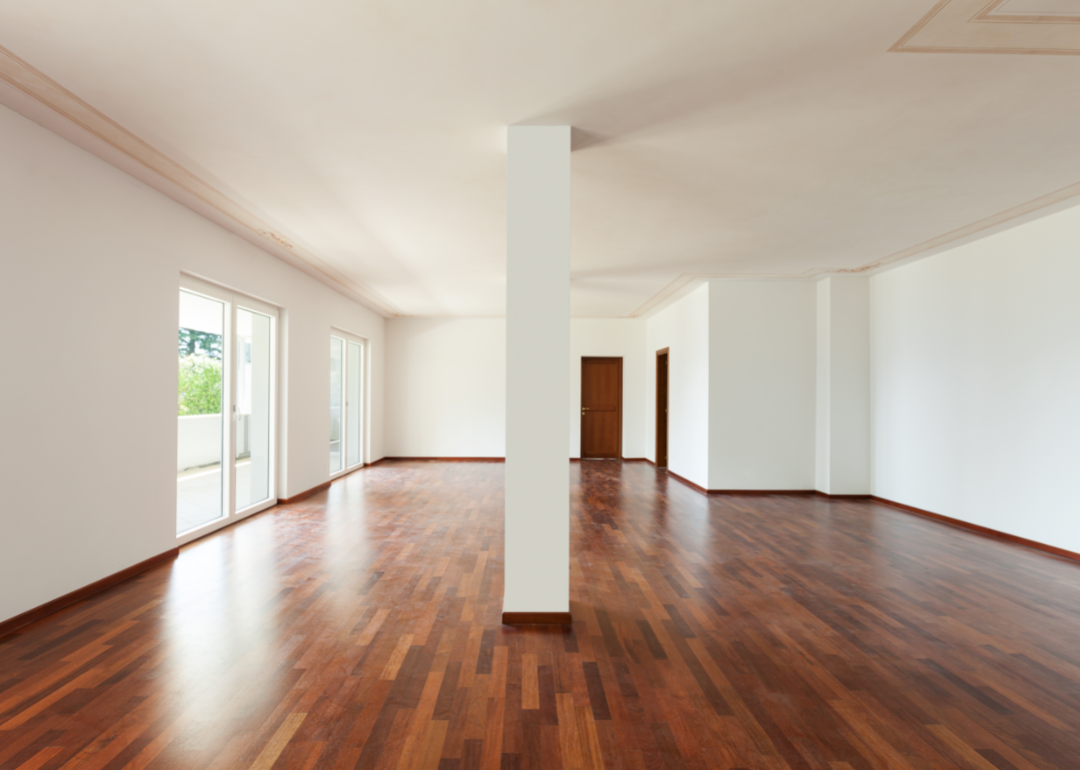 A large empty room with wood floors in a contemporary home