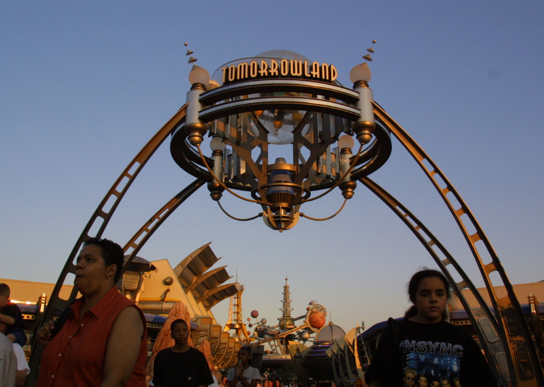 People walk through Tomorrowland in Walt Disney World's Magic Kingdom 
