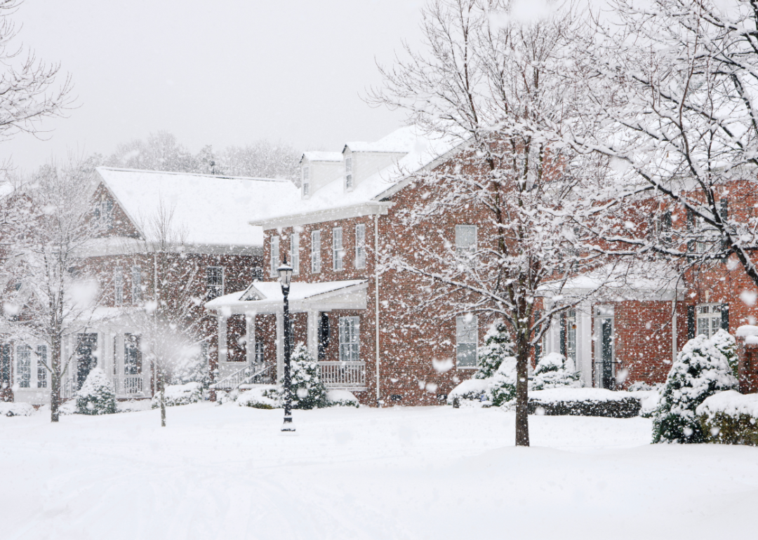 A row of brick houses in a snow storm.