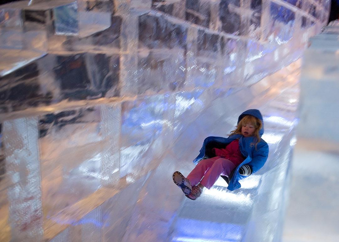 A child slides down an ice slide.