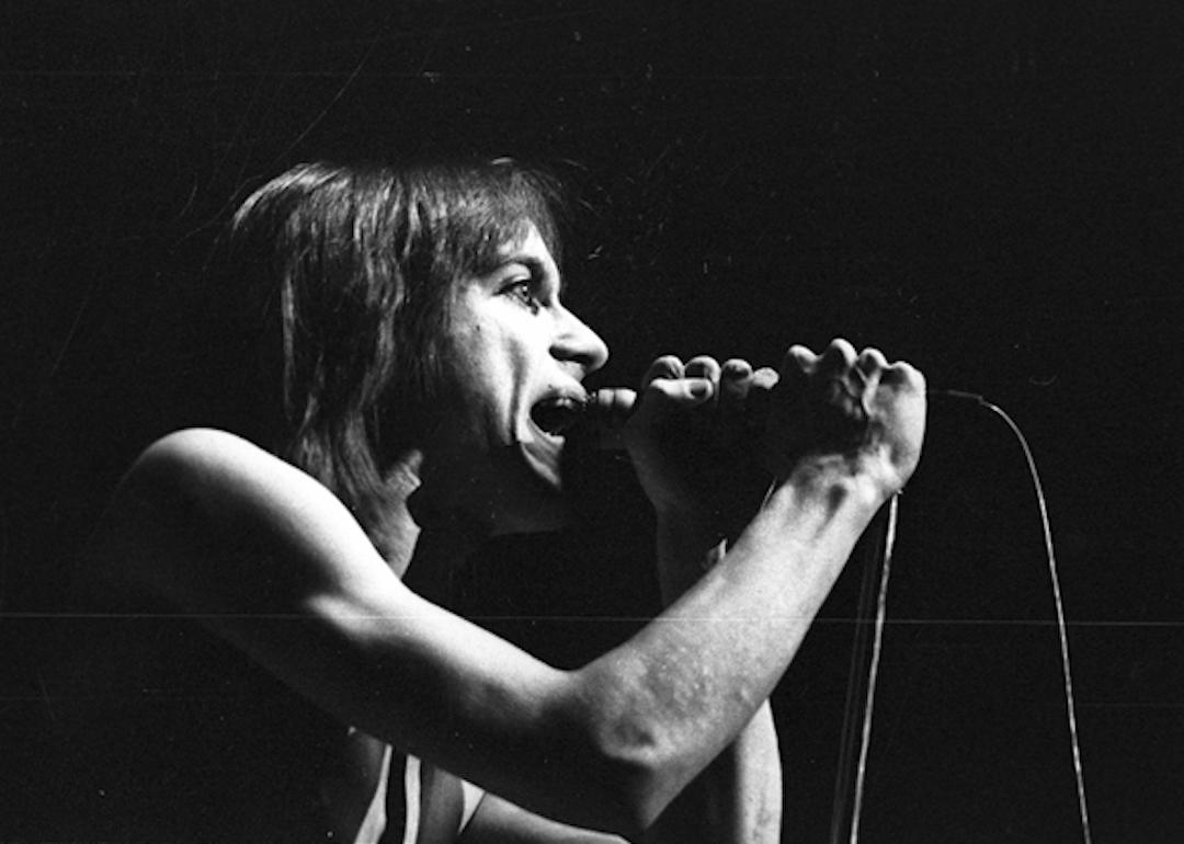 Iggy Pop performing on stage.