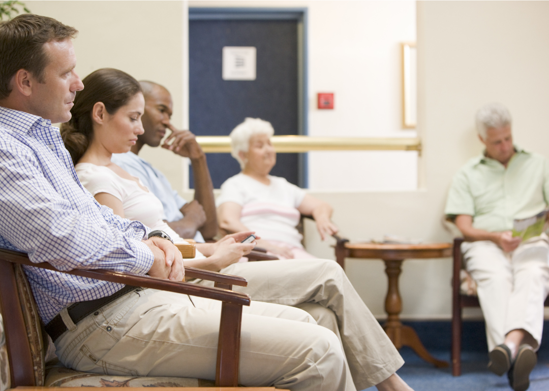 Five patients sit in doctor waiting room.