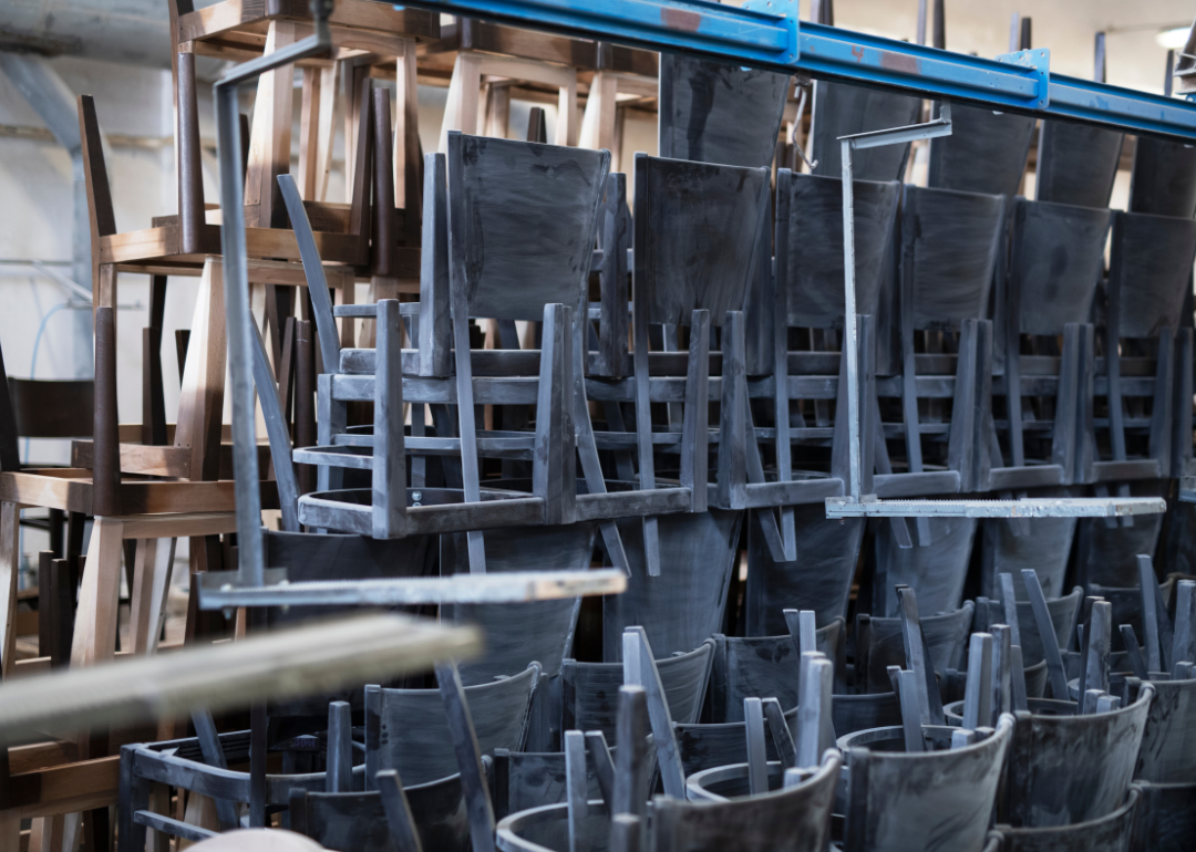 Stacks of chairs in a warehouse ready to be sold.