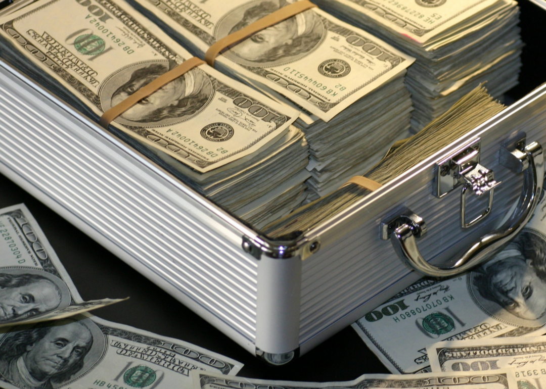 A silver briefcase containing stacks of cash.