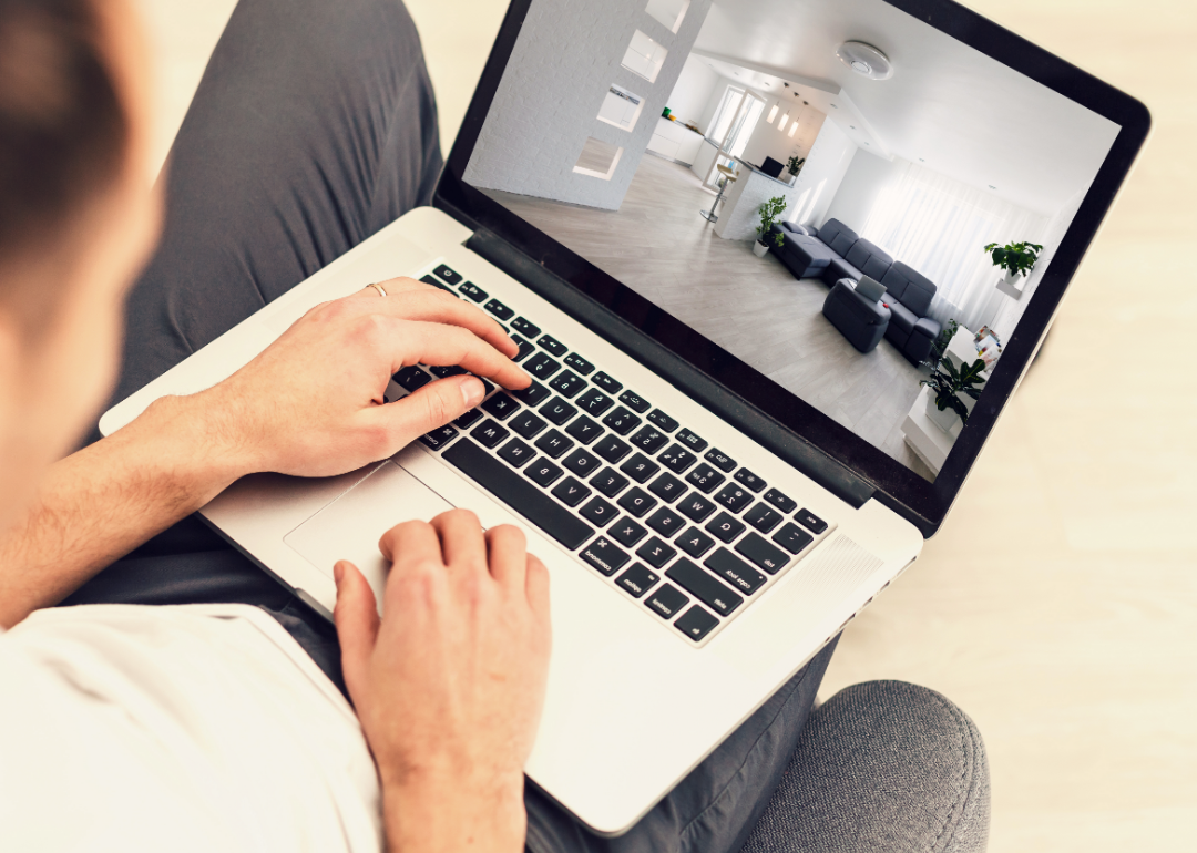 A person looking at a vacant apartment on their laptop.