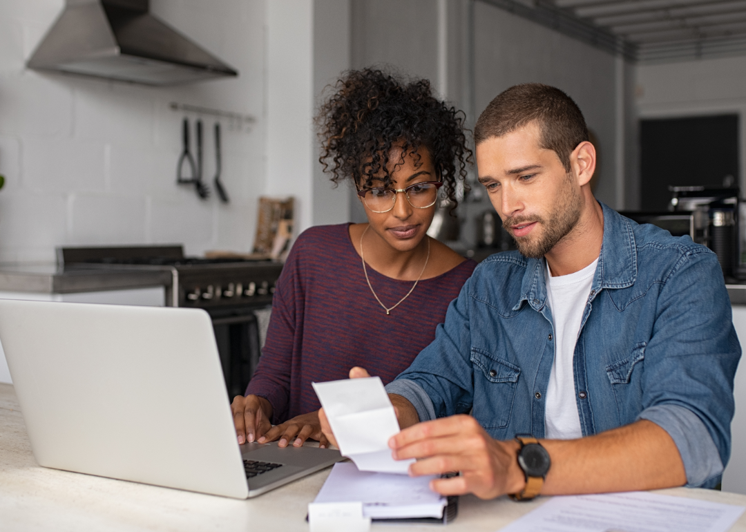 A young couple reviews financial documents together.