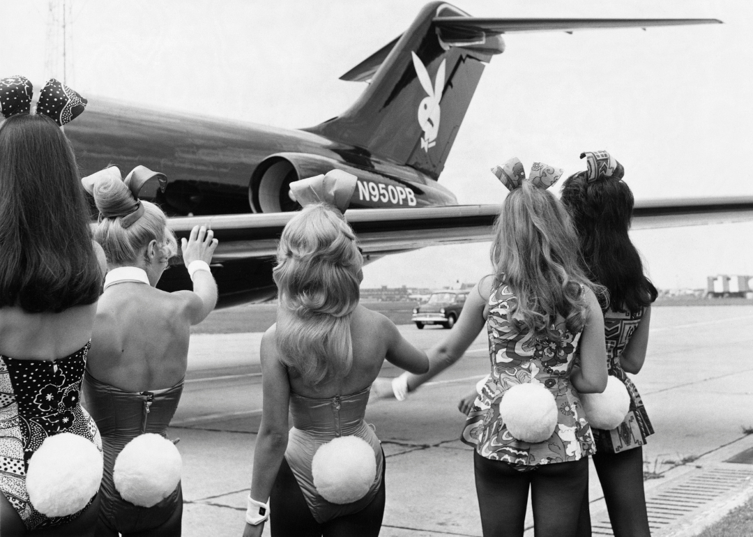 Playboy Bunnies wave as Hugh Hefner's private jet Big Bunny lands.